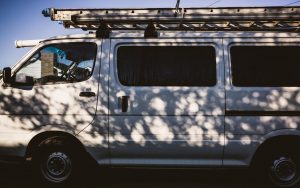 Seitenansicht eines weißen Handwerker-Transporters mit Dachträger im Ruhrgebiet.